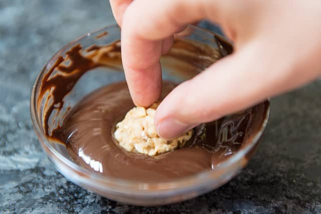 Dipping A Chilled Peanut Butter Bon Bon Into Melted Guittard Bittersweet Chocolate