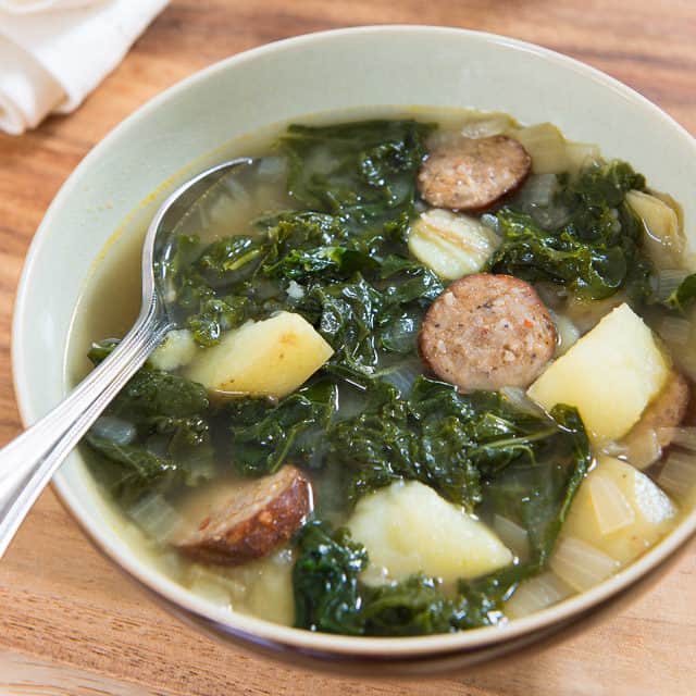 Sausage Kale and Potato Soup in Bowl with Spoon