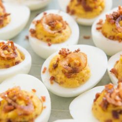 Bacon Bits and Crispy Shallot Deviled Eggs On Light Gray Plate