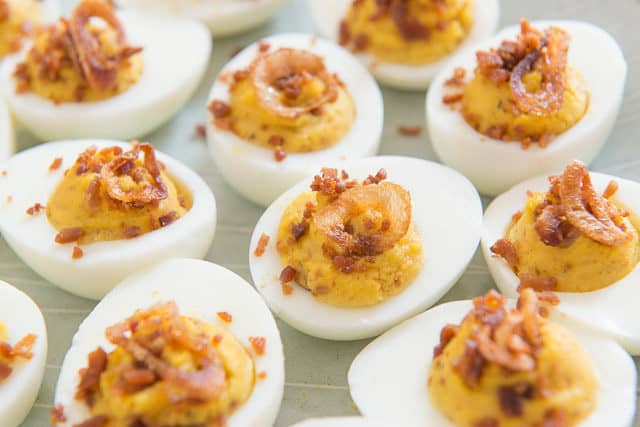 Bacon Bits and Crispy Shallot Deviled Eggs On Light Gray Plate 