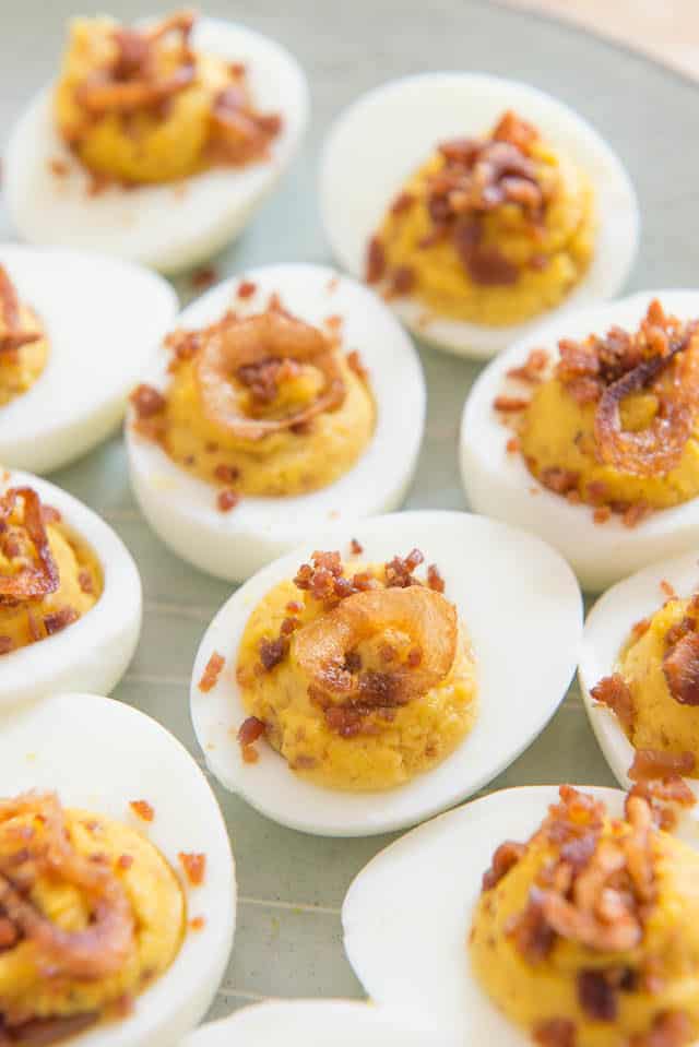 Bacon and Crispy Shallot Topped Deviled Eggs On Light Gray Plate