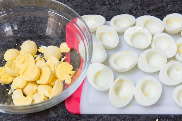 Separated Hardboiled Eggs For Deviled Eggs With Yolks In One Bowl And Egg Whites On A Board