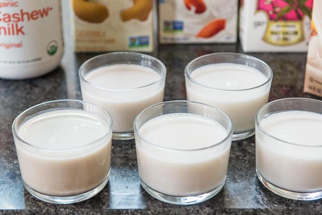 The Best Tasting Almond Milk And Cashew Milk In Tasting Glasses on Countertop