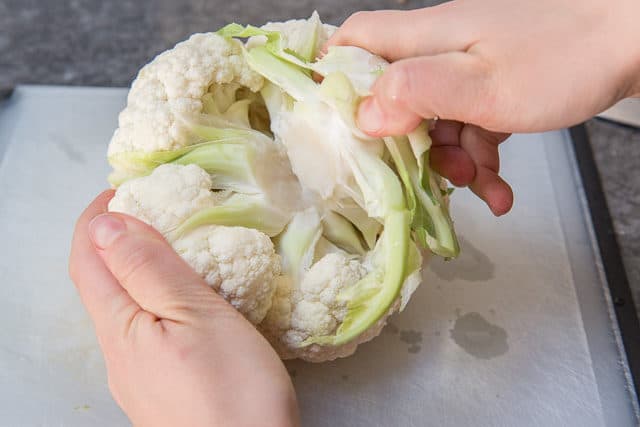 Removing the Bottom Stem off a Whole Cauliflower With Hand