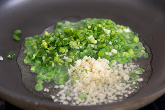 Scallions and Garlic Cooking in Oil in Skillet