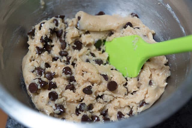 Vegan Chocolate Chip Cookie Dough In OXO Stainless Steel Bowl With Green Spatula