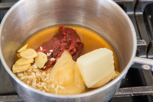 Butter, gochujang, soy sauce, garlic, ginger, honey, rice wine, and rice vinegar in a small saucepan