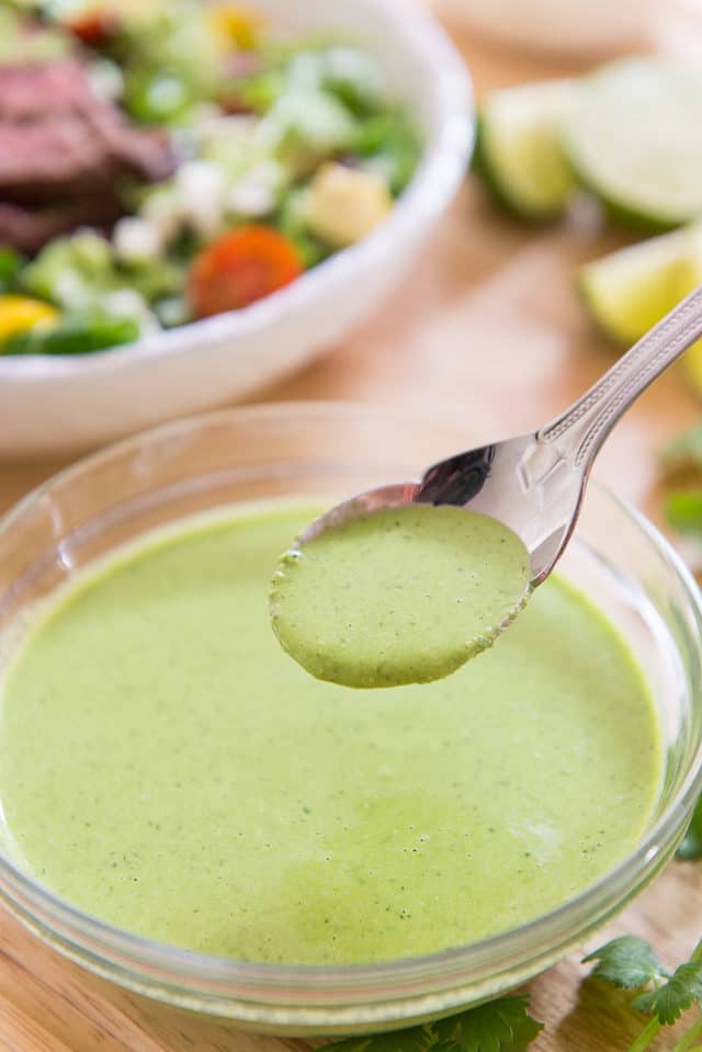 Lime Cilantro Dressing in Spoon Above Bowl