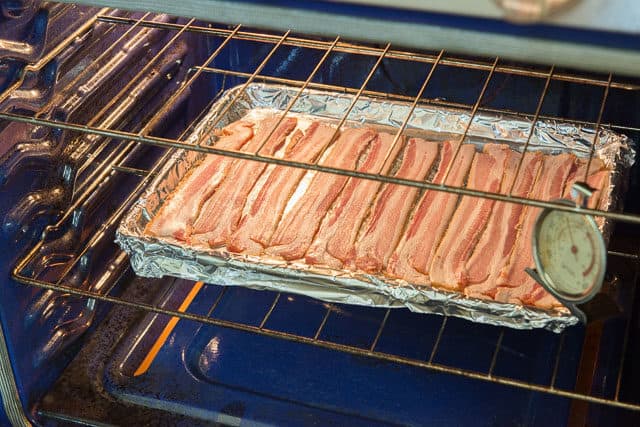 Sheet pan of Bacon on Middle Rack of Oven shows how to cook bacon in the oven