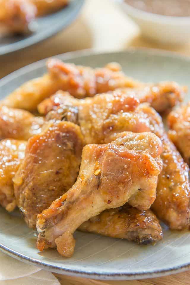 Honey Garlic Chicken Wings - Piled on a Plate with Red Pepper Flakes On Top