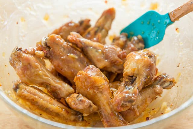 Tossing Baked Chicken Wings In the Garlic Honey Sauce