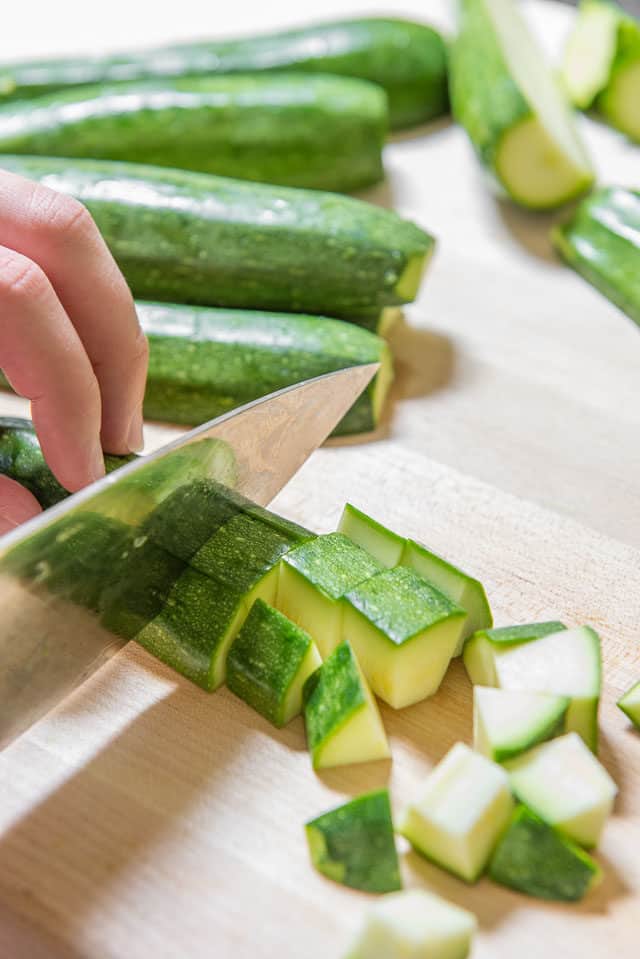 How to Cut Zucchini - On Wooden Board in Small Chunks