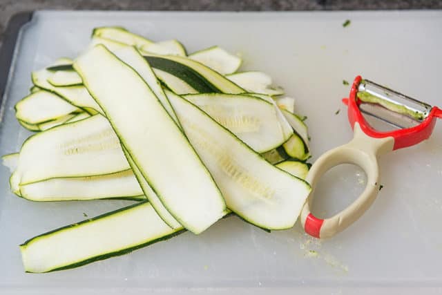 Shaved Zucchini Ribbons on Cutting Board with Peeler