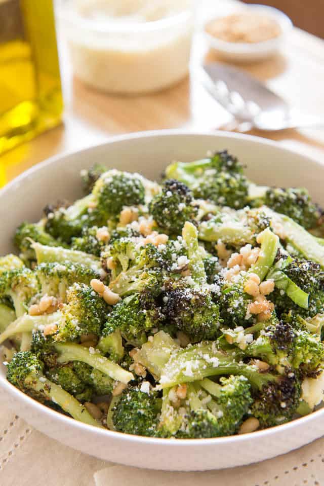 Charred Broccoli - in White Bowl with Pine Nuts and Cheese On Top