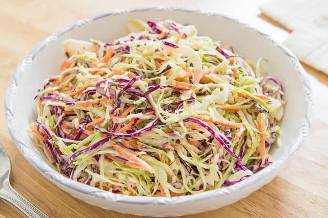 Cole Slaw - with Green and Purple Cabbage and Carrot Shreds in White bowl