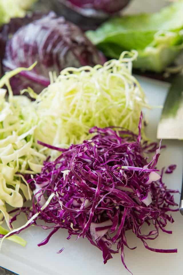 How to Cut Cabbage - Shown Shredded on a Cutting Board