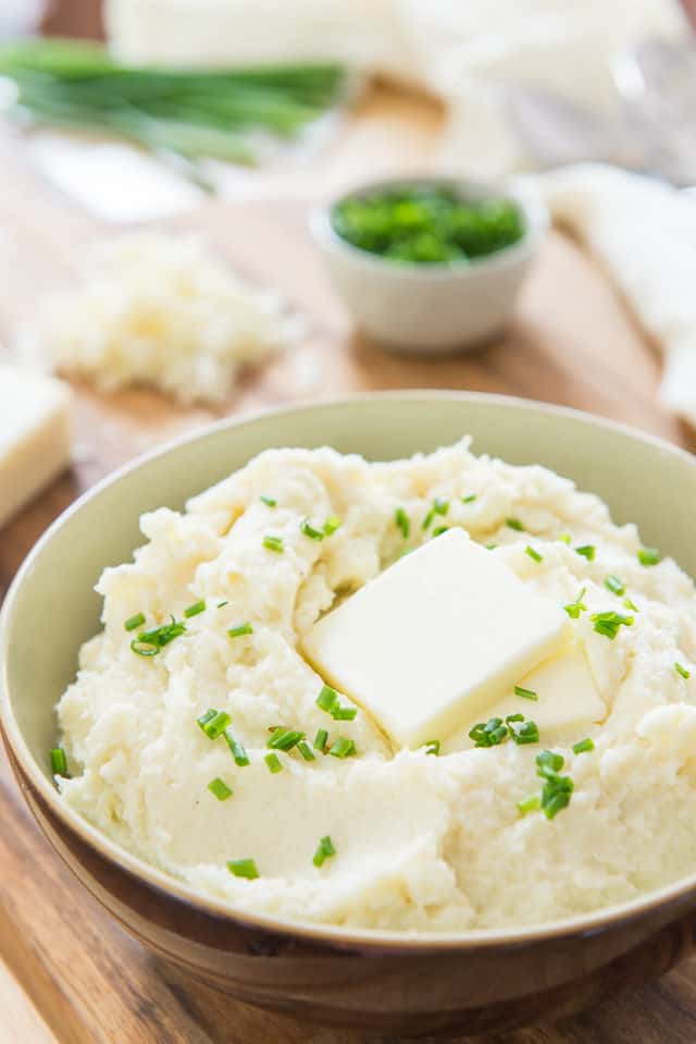 Cauliflower Mashed Potatoes - In a Brown Bowl with Chives and Pat of Butter On Top