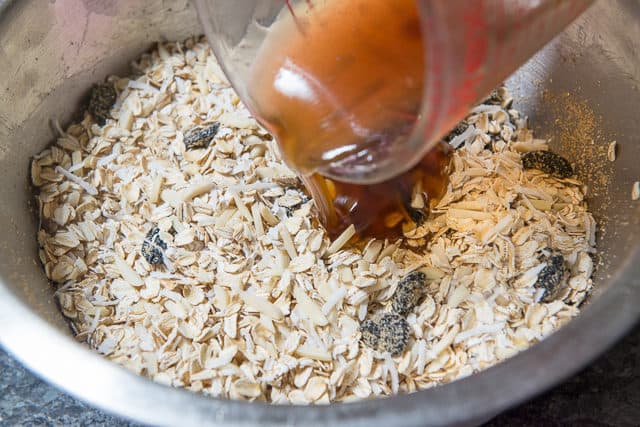 Pouring the Sweetener Over Dry Oat Ingredients in Bowl