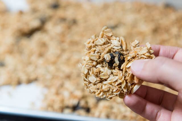 Holding Up a Cluster of Granola with Hand for Close Up View