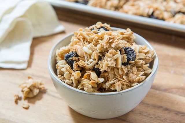 Homemade Granola - Served In a Gray Bowl on Wooden Board with napkin