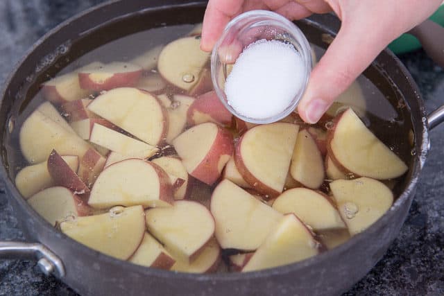 Adding Salt Into Pan with Red Potato Slices