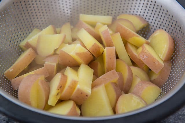 Boiled Red Potato Slices Draining In Colander