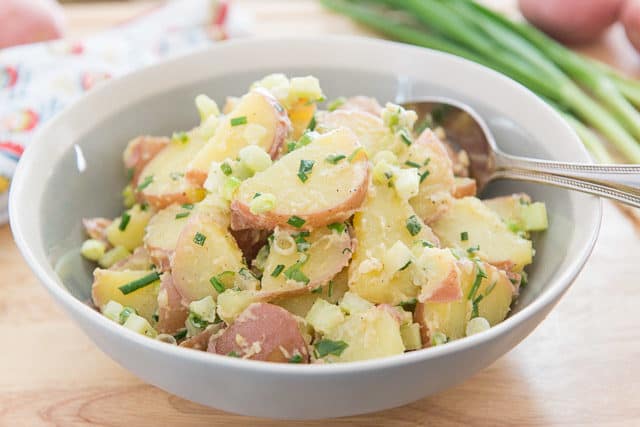 Red Potato Salad Recipe - In a Gray Bowl with Fresh Herbs and Scallions