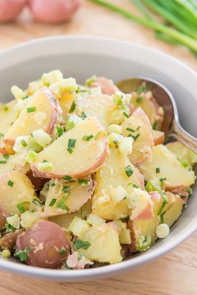 Red Potato Salad - In a Gray Bowl with Fresh Herbs and Scallions