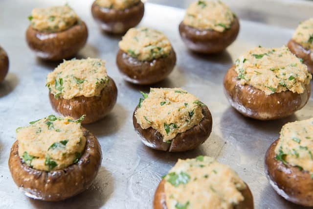 Unbaked Baby Bella Mushroom Caps Stuffed with Cream Cheese Filling on Sheet Pan