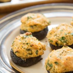 Stuffed Mushroom Caps On a Plate With Cheese Filling Browned