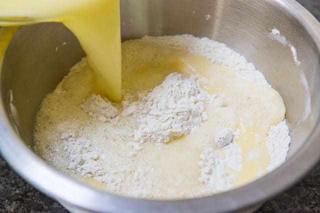 Pouring Buttermilk Egg Wet Ingredients Into Dry Flour Mix