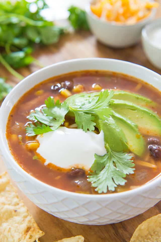 Chicken Tortilla Soup - Served in a White Bowl with Avocado Slices, Sour Cream, and Cilantro