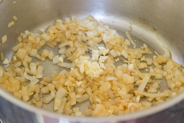 Softened Chopped Onions in a Soup Pot with Minced Garlic