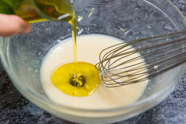 Lemon Vinaigrette Salad Dressing - With Olive Oil Being Poured Into Bowl