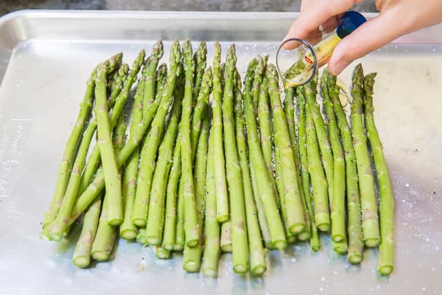 Asparagus Spears on Sheet Pan with Oil Drizzled Over