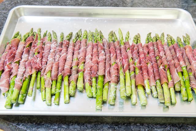 Asparagus and Prosciutto Rolled Together and Placed on Sheet Pan