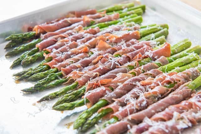 Asparagus Wrapped In Prosciutto and Garnished with Parmesan Grated Cheese