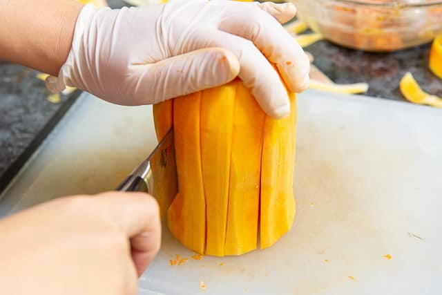 Cutting Peeled Butternut Squash Downward to Make Big Slices
