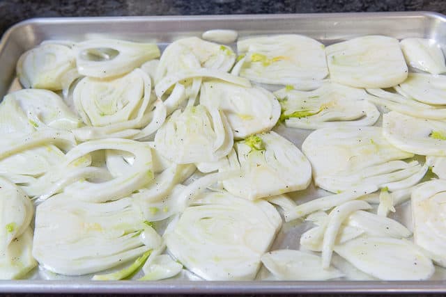 Single Layer of Sliced Fennel on Sheet Pan before Cooking Fennel