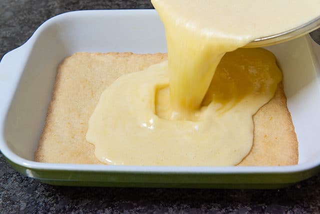 Pouring the Lemon Curd Filling Over the baked Shortbread Crust