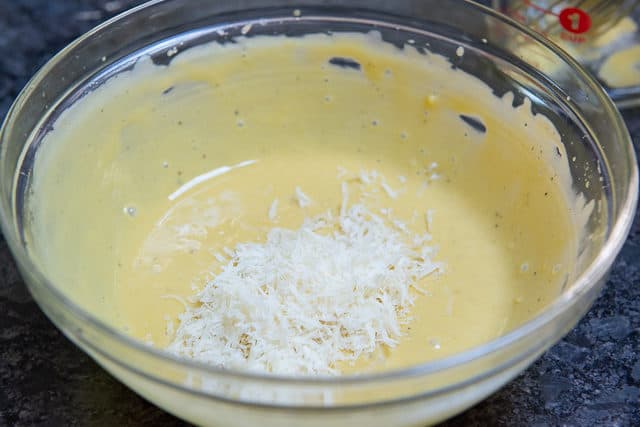 Grated Parmesan Cheese In Bowl of Dressing