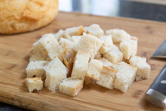 Cubes of Bread on a Wooden Board