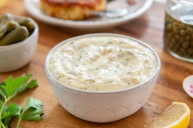 Tartar Sauce Recipe In a white Bowl with Spoon on Wooden Board