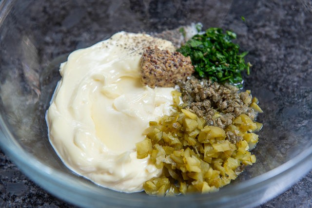 Tartar Sauce Ingredients - In Glass Bowl with Mayonnaise, Cornichons, Mustard, Capers, and Herbs