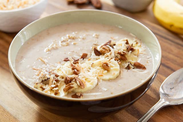Overnight Steel Cut Oats Recipe Served in a Brown Bowl with Banana Slices and Pecans