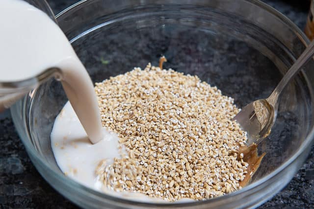 Steel Cut Oats Added To Bowl with Almond Milk Pouring In