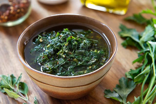 Chimichurri Sauce - Served in a Brown Bowl on Wooden Board