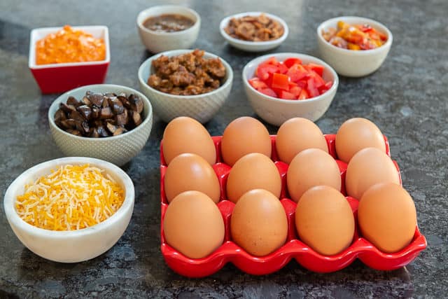 Omelette Ingredients - Eggs, Cheese, Mushrooms, Sausage, Tomatoes, on Counter