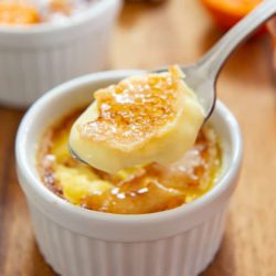 Creme Brulee in White Ramekin with Spoon Showing Caramelized Top