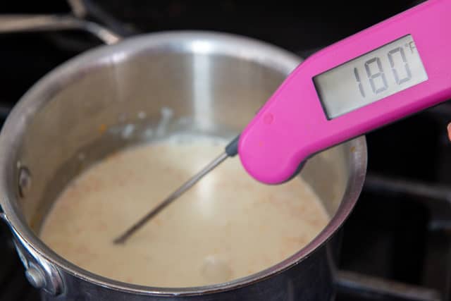 Scalded Cream in Saucepan with Thermometer Verifying